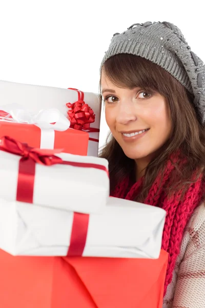 Portrait of a pretty woman holding pile of gifts — Stock Photo, Image