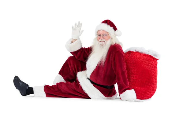 Santa se nachází naklonil na svou tašku a vlny — Stock fotografie