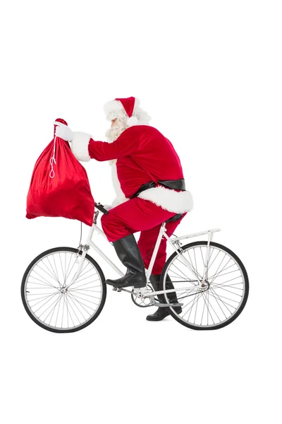 Santa cykling och hålla sin säck — Stockfoto
