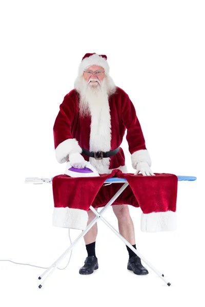 Santa está planchando sus pantalones. — Foto de Stock