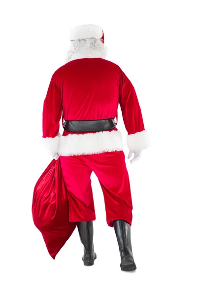 Widok z tyłu santa Claus trzyma worek — Zdjęcie stockowe