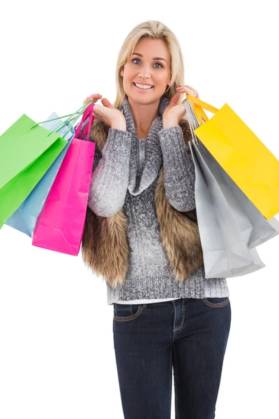 Blonde in winter clothes holding shopping bags — Stock Photo, Image