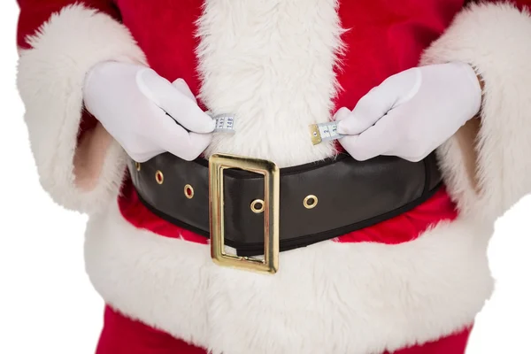 Santa claus met behulp van meten tape — Stockfoto