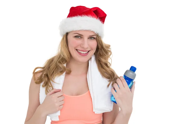 Festive fit blonde holding bottle of water — Stock Photo, Image