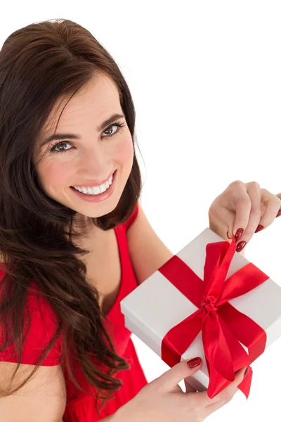 Smiling brunette opening gift — Stock Photo, Image