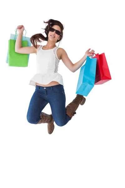 Feliz morena saltando con bolsas de compras — Foto de Stock