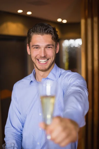 Handsome man holding flute of champagne — Stock Photo, Image