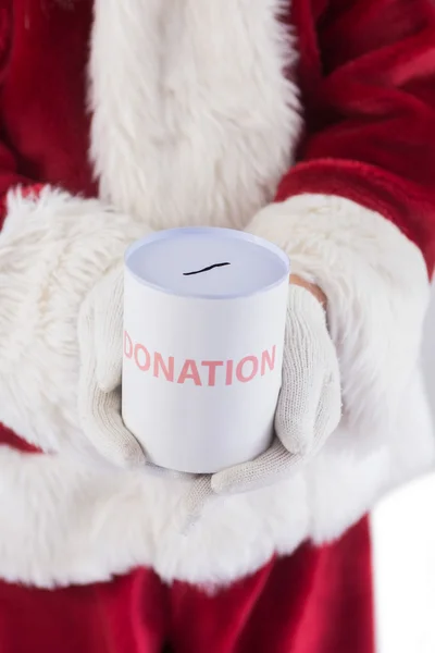 Santa innehar en kan för donationer — Stockfoto