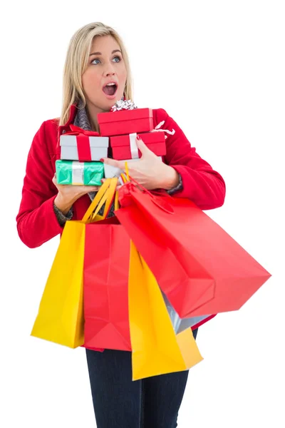 Festive blonde holding many gifts — Stock Photo, Image