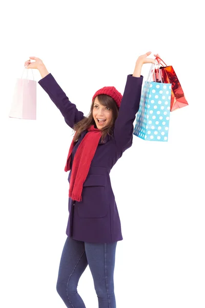 Brunette in winter clothes holding shopping bags — Stock Photo, Image