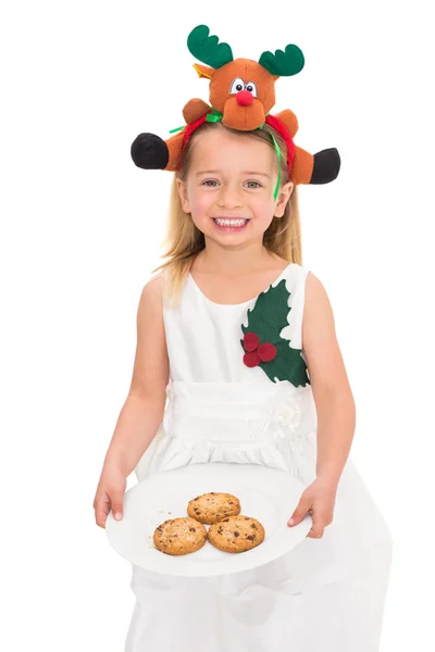 Festive little girl holding fresh cookies — Stock Photo, Image