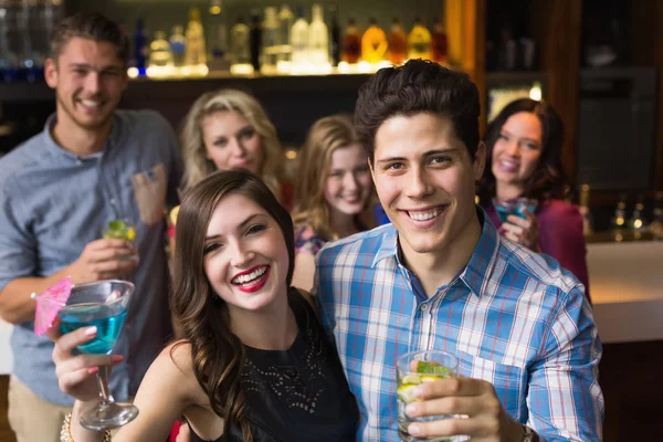 Happy friends drinking cocktails together — Stock Photo, Image