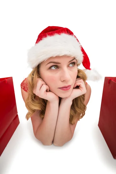 Close up of a thoughtful woman lying between shopping bags — Stock Photo, Image