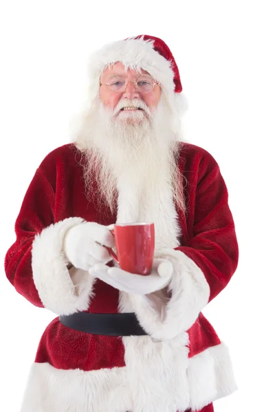 Santa hält eine rote Tasse in der Hand — Stockfoto