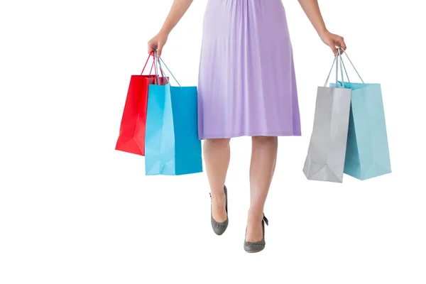 Mid section of woman holding shopping bags — Stock Photo, Image