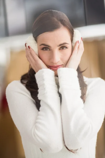 Pretty brunette with ear muffs — Stock Photo, Image