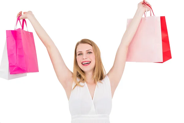 Young woman holding up shopping bags — Stock Photo, Image