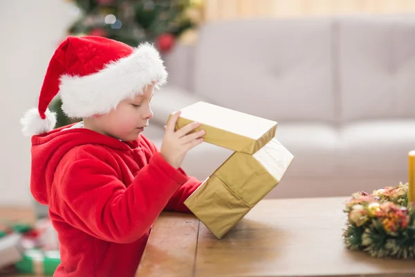 Festive little boy opening a gift — Stock Photo, Image