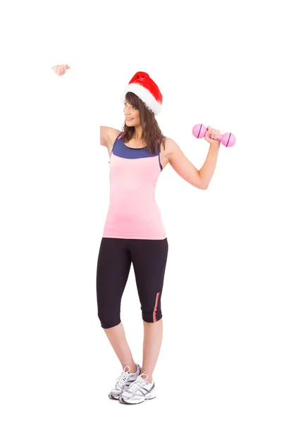 Festive fit brunette holding poster with dumbbell — Stock Photo, Image