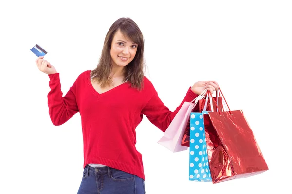 Brunette holding gift and credit card — Stock Photo, Image