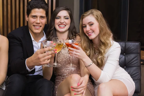 Happy friends having a drink together — Stock Photo, Image