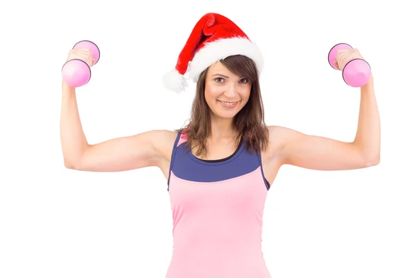 Woman in santa hat holding hand weight — Stock Photo, Image