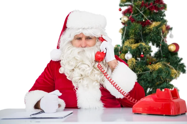 Irritated santa claus on the phone Royalty Free Stock Images