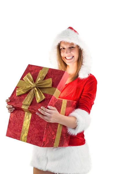Festive pretty brunette opening a gift Stock Photo