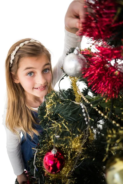 Festive little girl decorating christmas tree Stock Photo