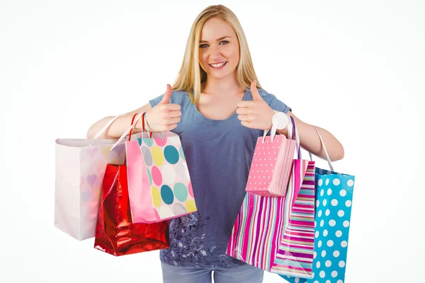 Pretty young blonde holding shopping bags Stock Photo