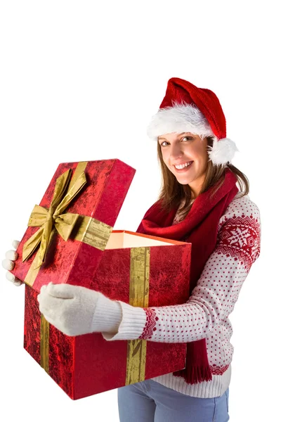 Festive brunette opening a gift Royalty Free Stock Images