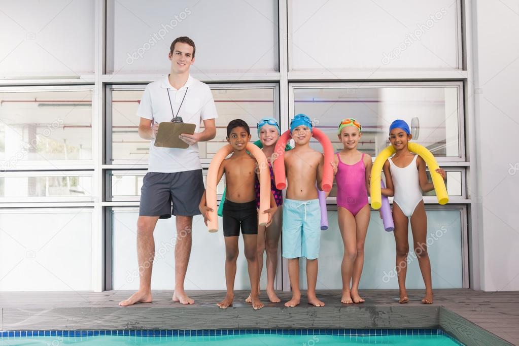 Swimming coach with students poolside — Stock Photo © Wavebreakmedia