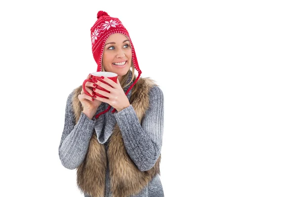 Blonde in winter clothes holding a mug — Stock Photo, Image