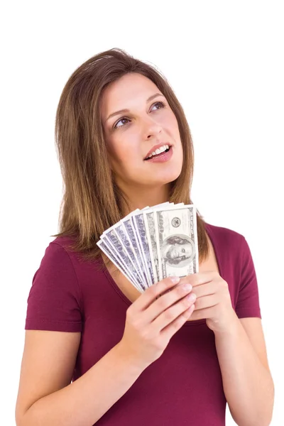 Feestelijke brunette houdt haar contant geld — Stockfoto
