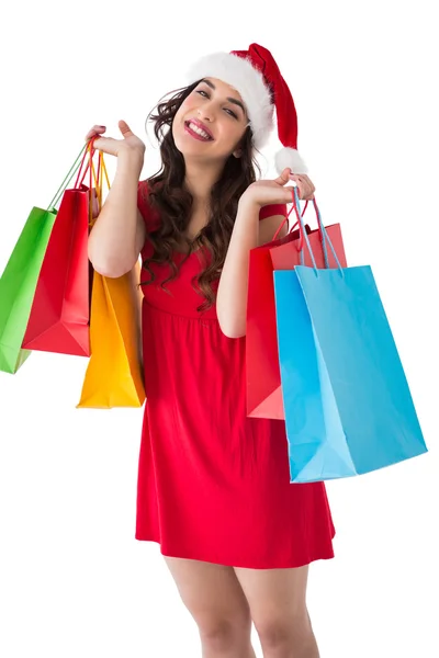 Festive brunette holding shopping bags — Stock Photo, Image