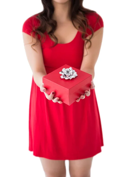 Festive brunette holding red gift — Stock Photo, Image