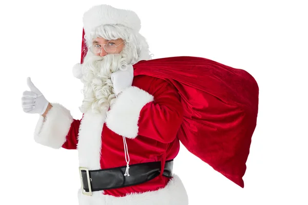 Positiver Weihnachtsmann mit Sack und Daumen nach oben — Stockfoto