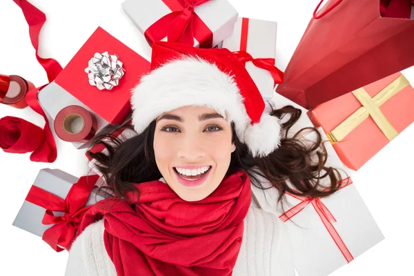 Festive brunette lying near christmas presents — Stock Photo, Image