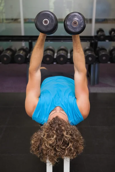 Man exercising with dumbbells in gym — Stock Photo, Image