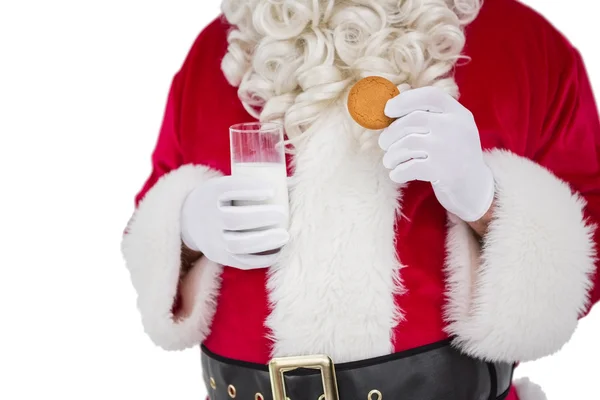 Santa sosteniendo vaso de leche y galletas —  Fotos de Stock