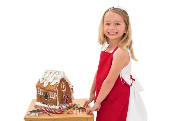 Festive little girl making gingerbread house — Stok fotoğraf