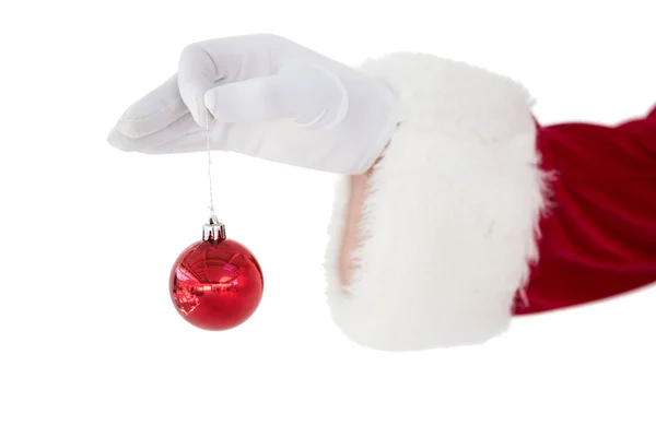 Santa claus holding red bauble — Stock Photo, Image