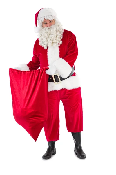 Uśmiechający się otwierając worek Świętego Mikołaja — Zdjęcie stockowe