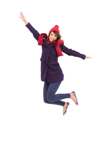 Woman in warm clothing jumping — Stock Photo, Image