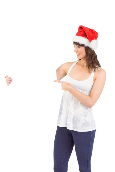 Pretty girl in santa hat holding poster — Stock Photo, Image