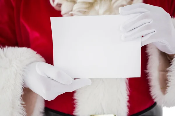 Santa holding kartı orta bölümünde — Stok fotoğraf
