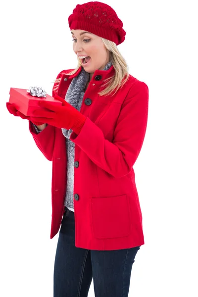 Festive blonde holding red gift — Stock Photo, Image