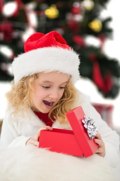 Festive little girl looking at gift — Stock Photo, Image