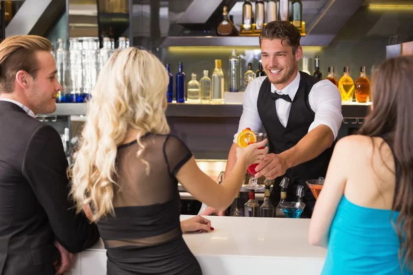 Attractive friends being served cocktails — Stock Photo, Image