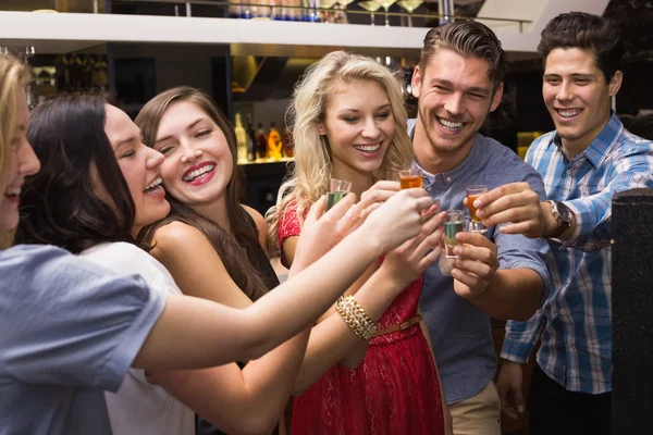 Happy friends having a drink together — Stock Photo, Image